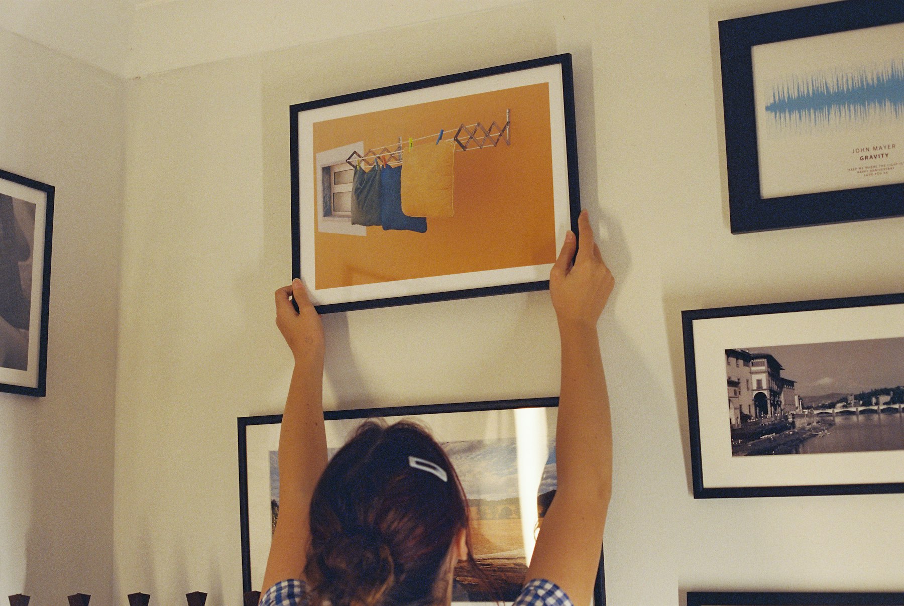 Installing framed artworks on a white wall Installing framed artworks on a white wall