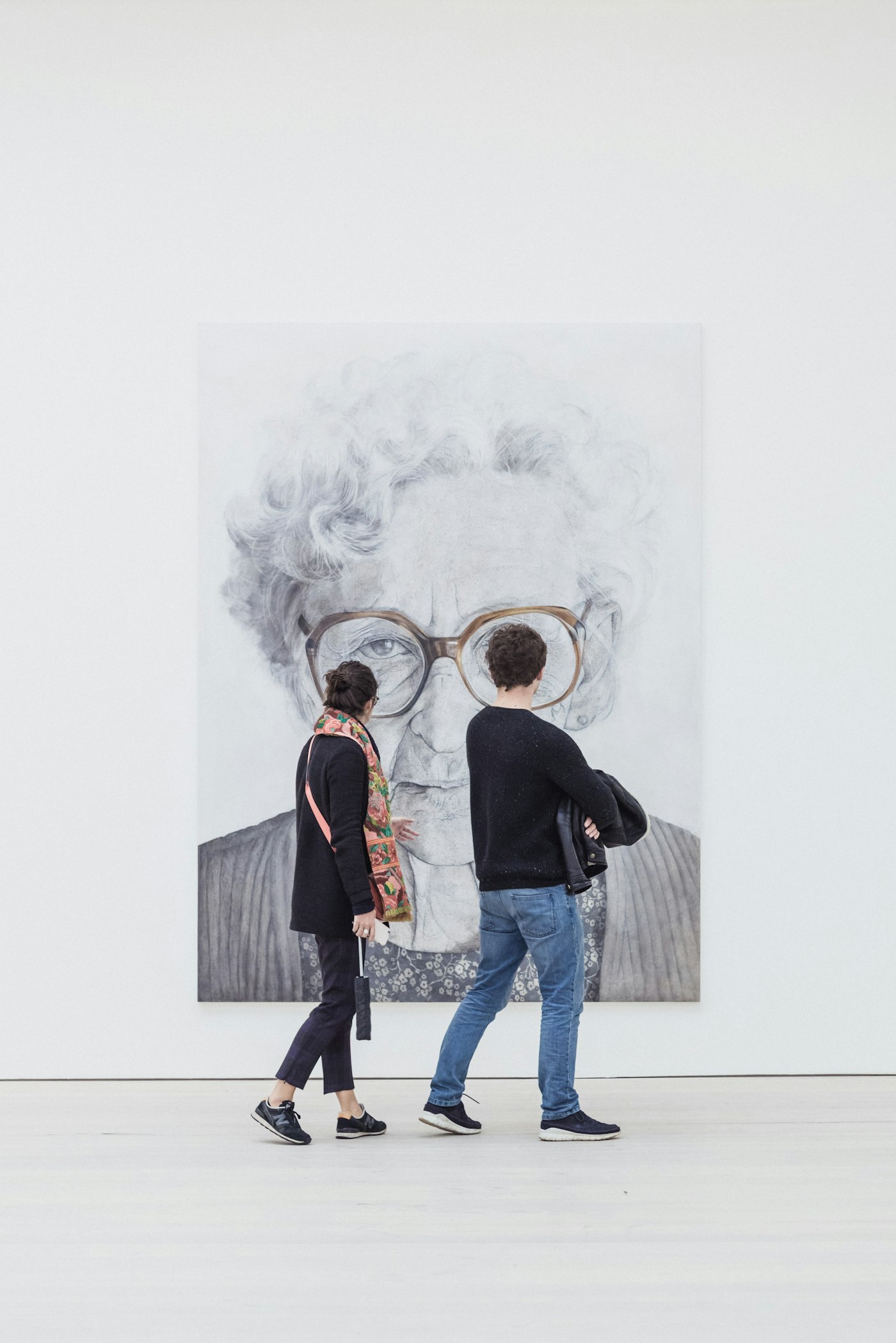 Visitors looking at a painting