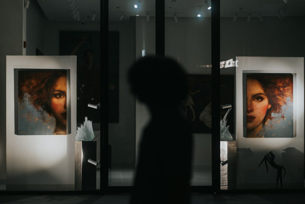 Visitor standing in front of a large portrait photograph