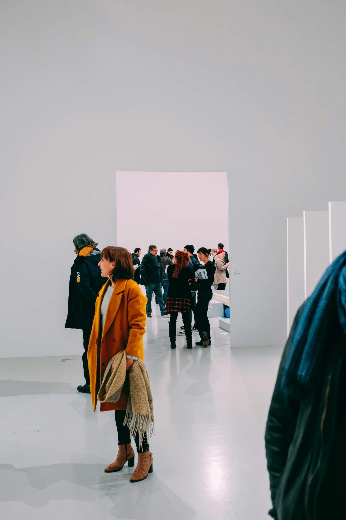 Woman standing in a white exhibition room Woman standing in a white exhibition room